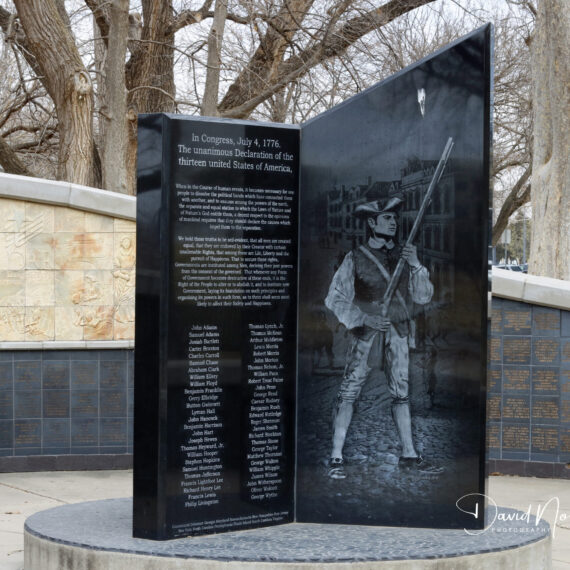 Revolutionary War monument with soldier engraving.