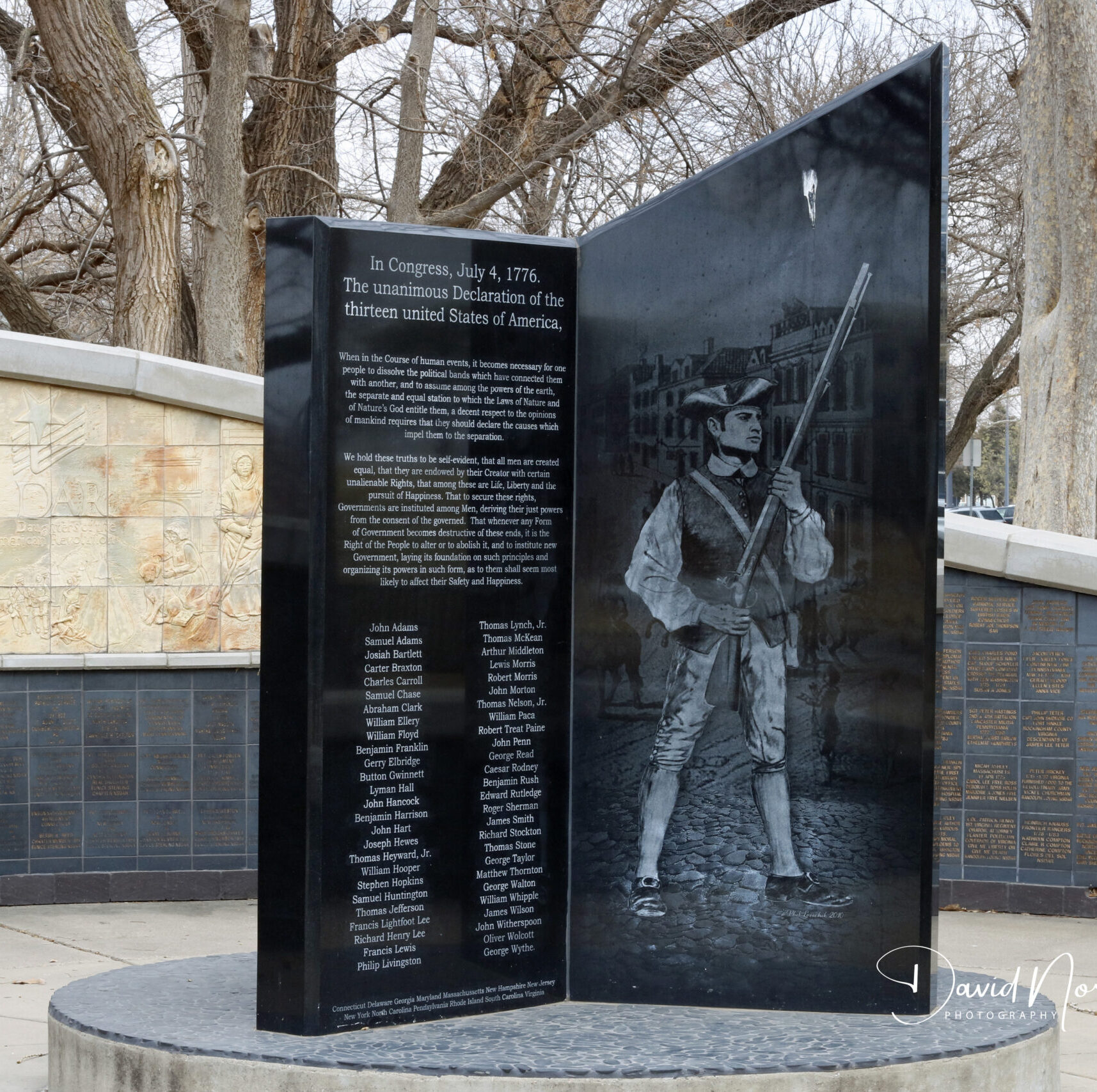 Revolutionary War monument with soldier engraving.