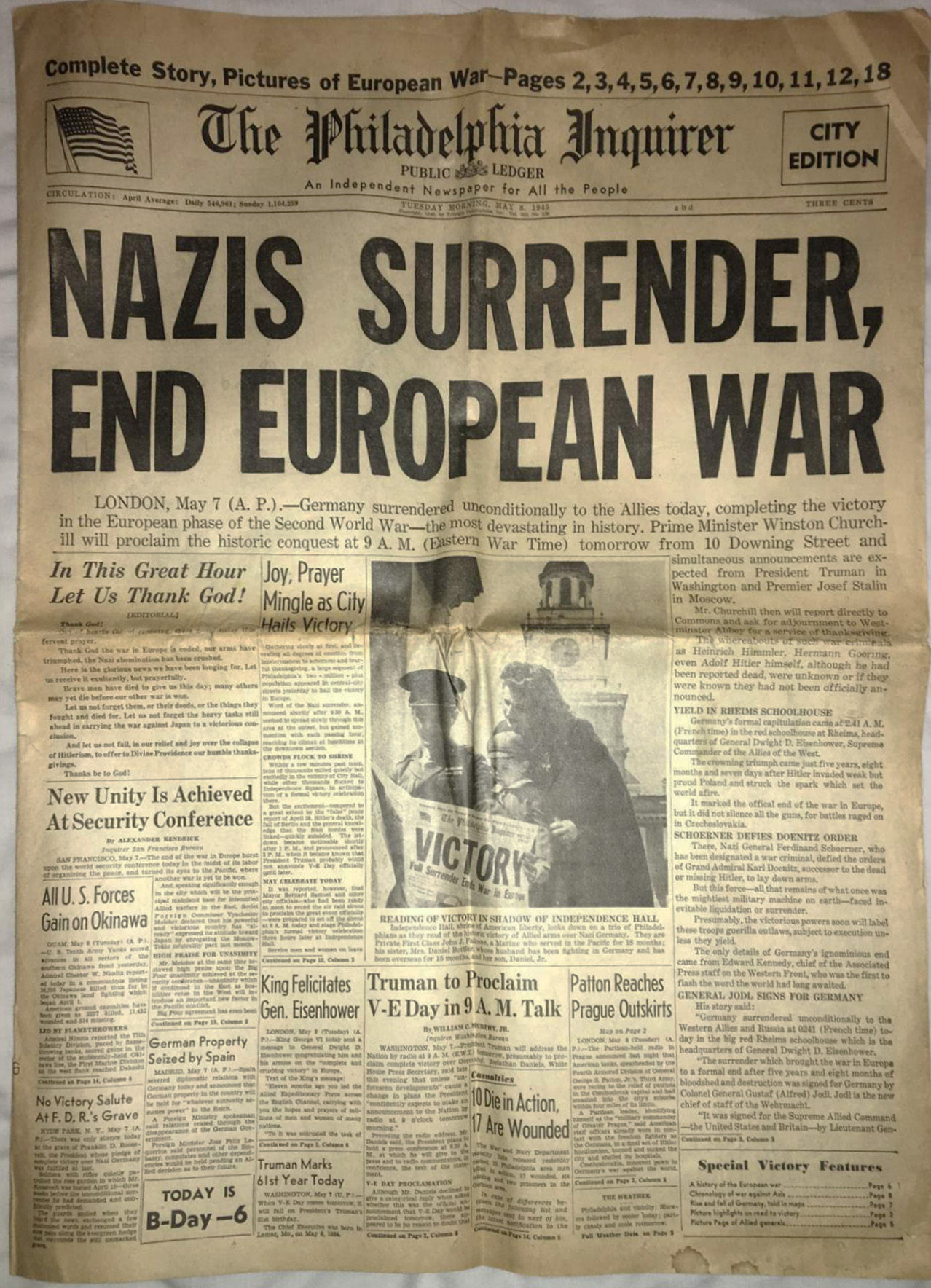 Historic newspaper headline: Nazis surrender, war ends.