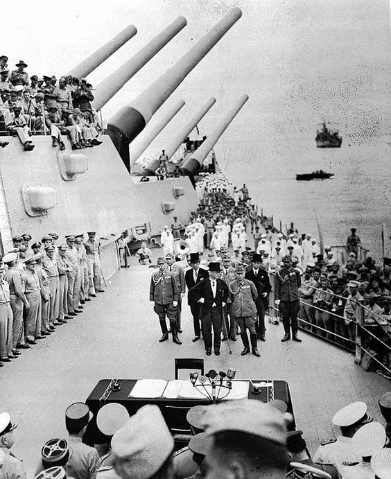 Ceremony aboard a military ship with officials.